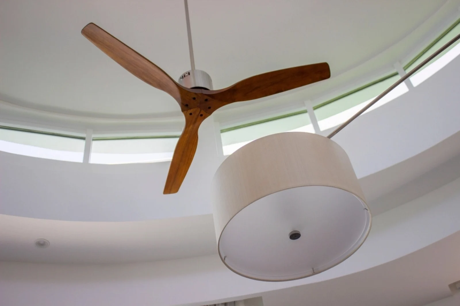 A ceiling-mounted fan with white blades