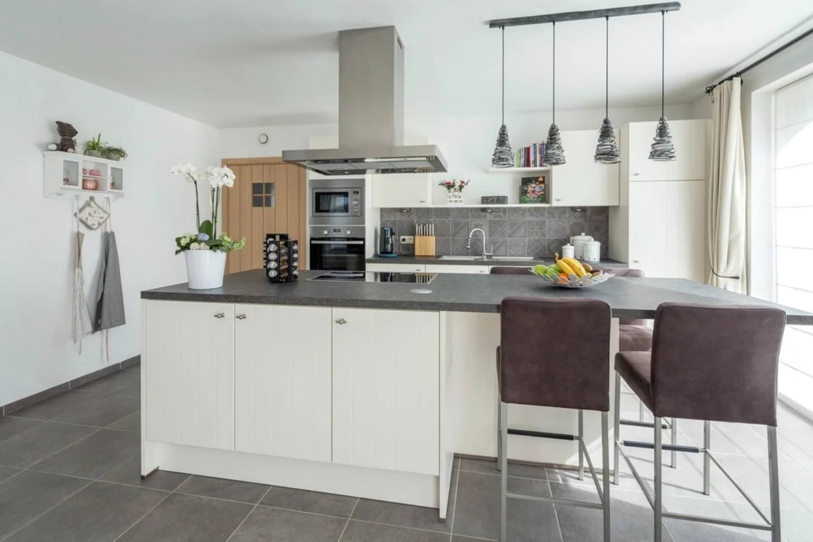 Round surface-mounted puck lights casting individual pools of light beneath cabinets